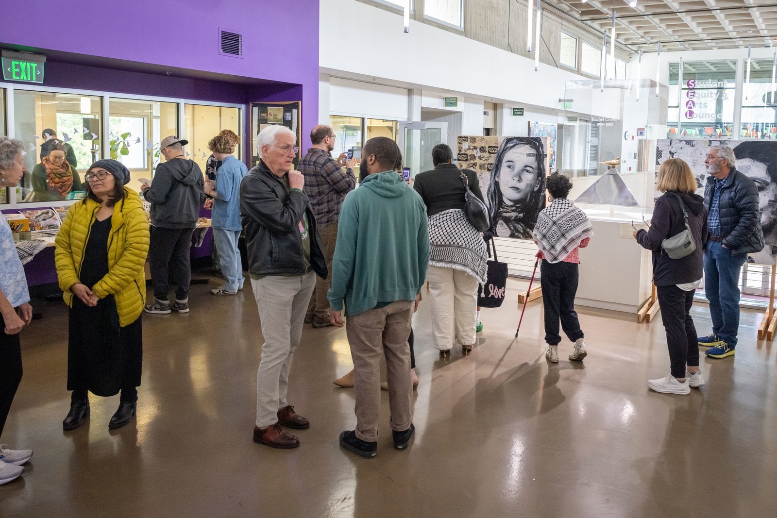 Community members gather among artwork and archives before the rededication ceremony